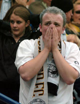 A Hereford United supporter tries to contain his emotions.